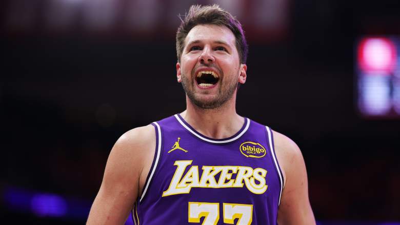 Close-up of a Los Angeles Lakers player in a purple No. 77 jersey smiling during an NBA game as the team prepares for a pivotal offseason.