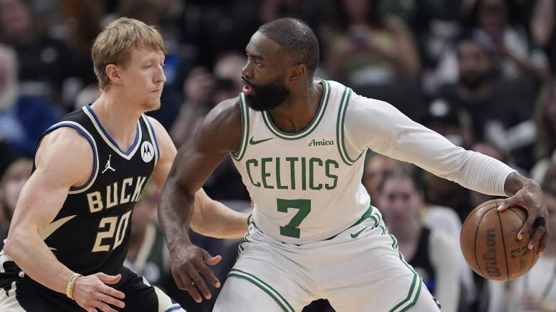 Boston Celtics star Jaylen Brown handles the ball against Milwaukee Bucks guard AJ Green during an NBA game as trade speculation involving Giannis Antetokounmpo intensifies.