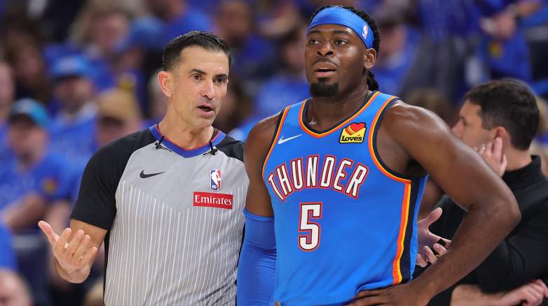 NBA referee Zach Zarba speaks with Oklahoma City Thunder forward Luguentz Dort during a game.
