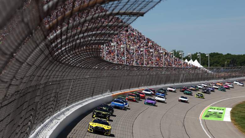 The NASCAR Cup Series field races through a turn during the FireKeepers Casino 400 at Michigan International Speedway.