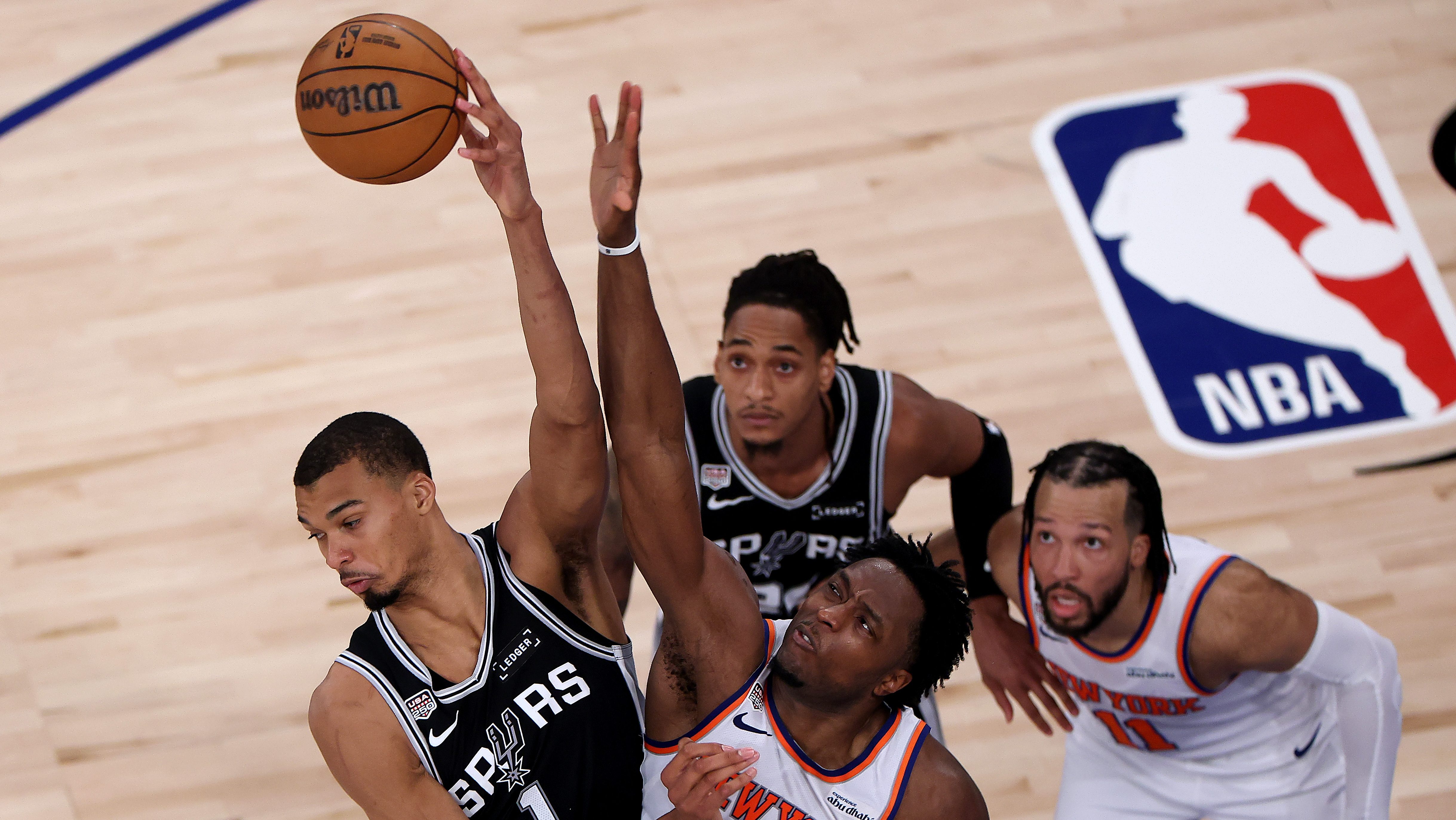 Victor Wembanyama of the San Antonio Spurs battles OG Anunoby of the New York Knicks for a rebound during Game 4 of the 2026 NBA Finals at Madison Square Garden.