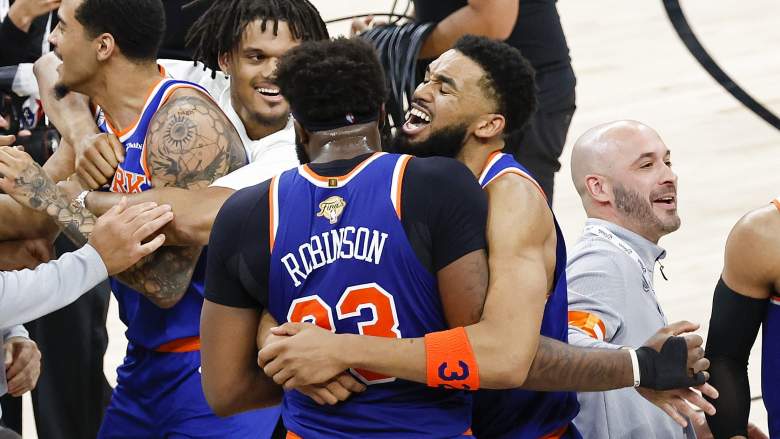Mitchell Robinson hugs Karl-Anthony Towns during the Knicks' championship celebration before entering free agency.