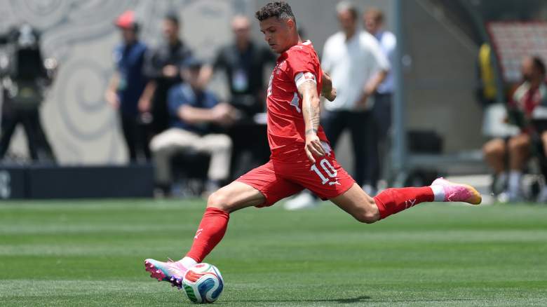 Granit Xhaka of Switzerland kicks the ball.