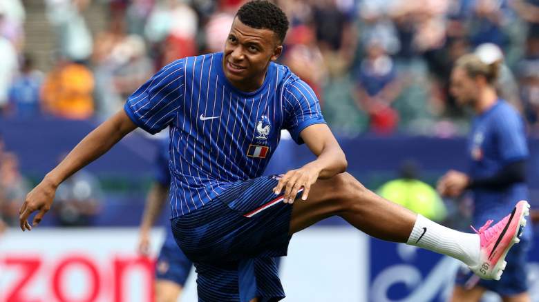 Kylian Mbappe takes part in the warm-up.