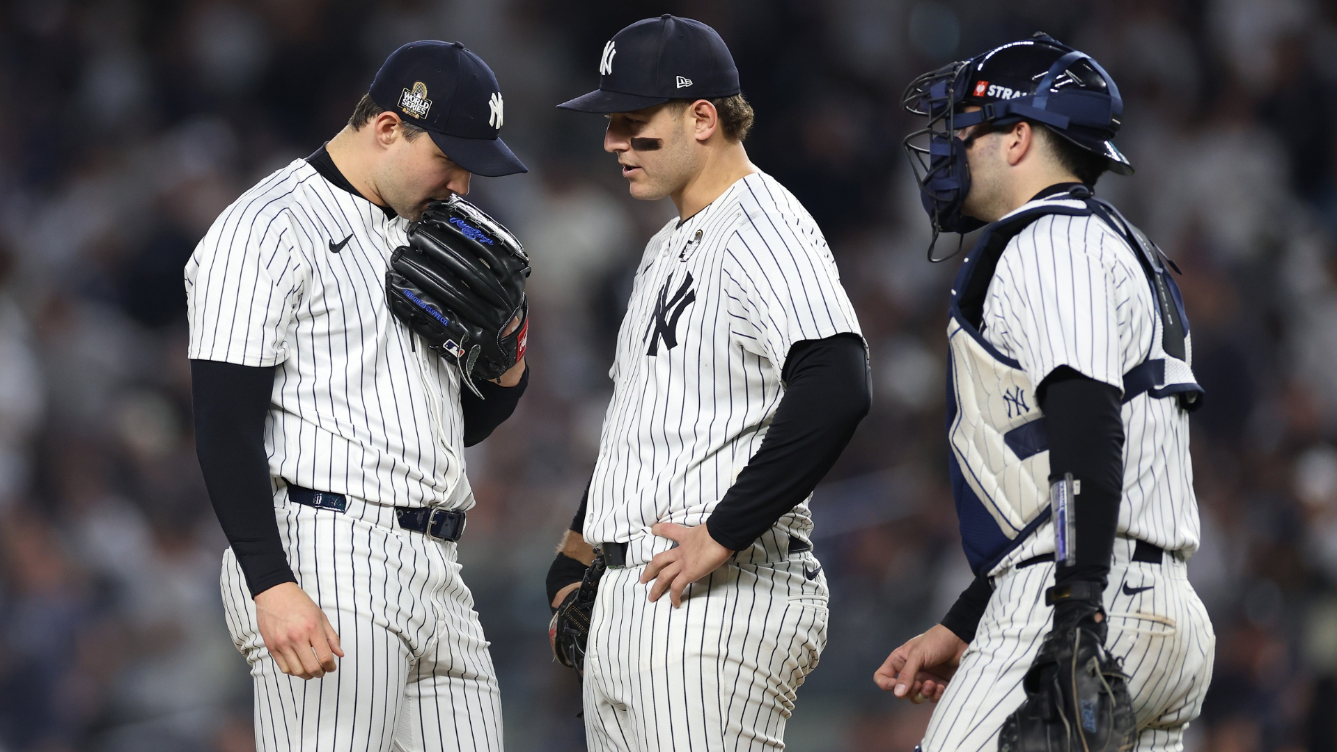 Tommy Kahnle #41 of the New York Yankees recieves a mound visit from Anthony Rizzo #48 and Austin Wells #28 during the eighth inning of Game Five of the 2024 World Series against the Los Angeles Dodgers at Yankee Stadium on October 30, 2024 in the Bronx borough of New York City. (Photo by Sarah Stier/Getty Images)