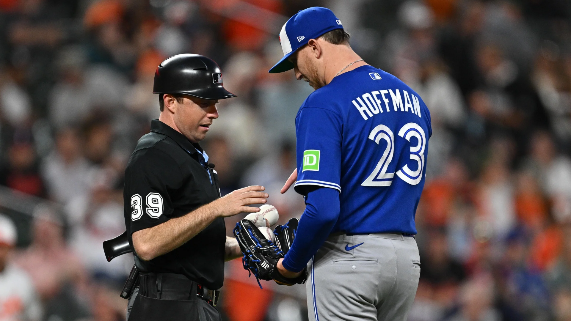 Pitcher Jeff Hoffman #23 of the Toronto Blue Jays picks out the ball he wants from umpire Tyler Jones #39 in the seventh inning against the Baltimore Orioles at Oriole Park at Camden Yards on May 28, 2026 in Baltimore, Maryland. (Photo by Jamie Sabau/Getty Images)