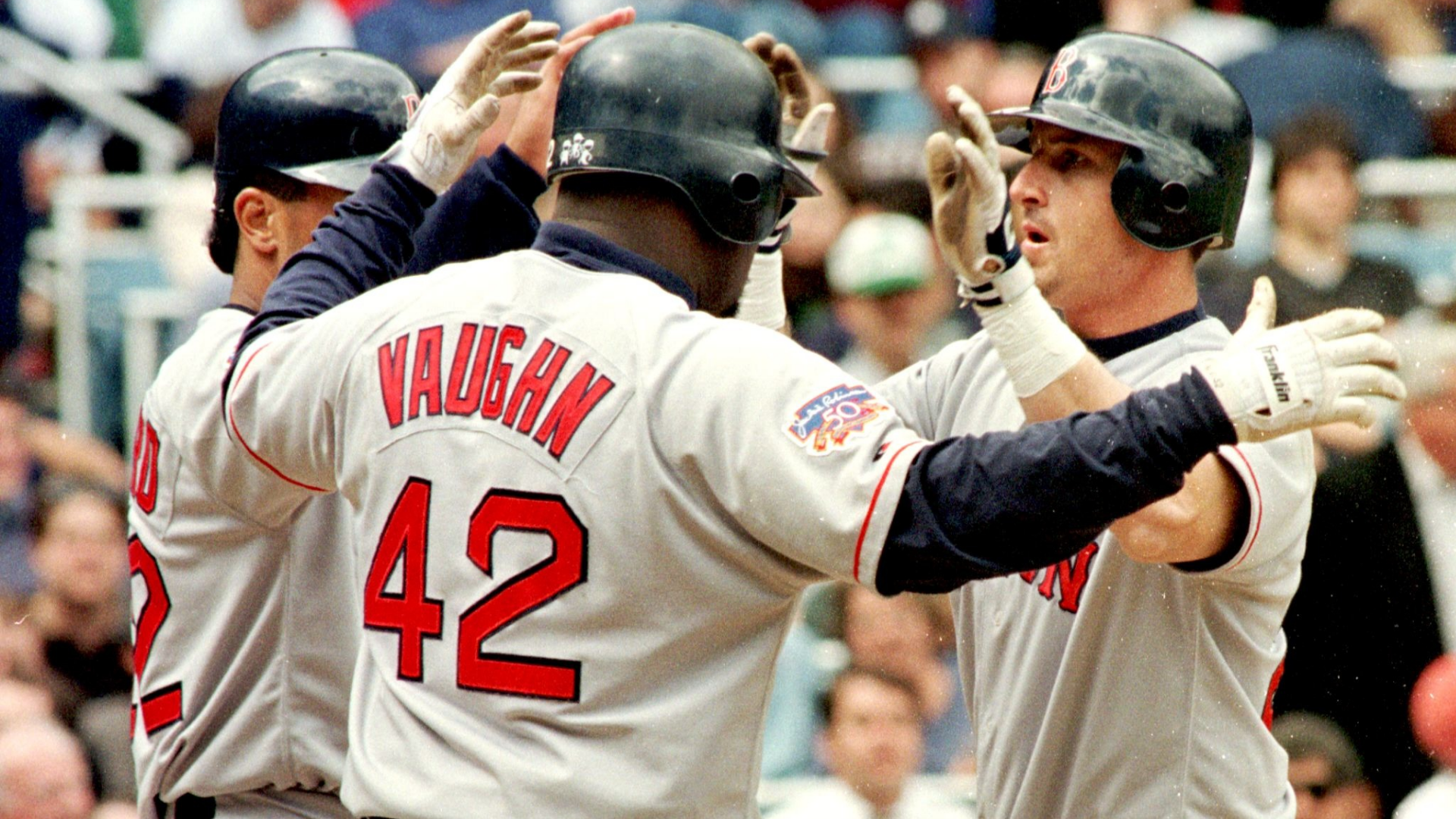 Boston Red Sox Mike Stanley (R) is congratulated at homeplate by teammates Mo Vaughn (C) and Wil Cordero (L) after Stanley drove them both in with a game-winning three-run home run in the fifth inning against the New York Yankees 22 May in New York. The Red Sox won 8-2. (Photo by HENNY RAY ABRAMS/AFP via Getty Images)