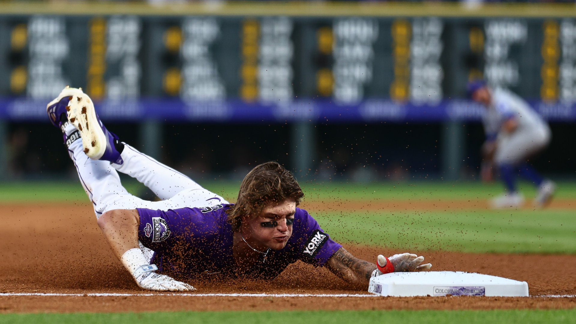 Cole Carrigg #16 of the Colorado Rockies slides into third base with a triple in the fifth inning against the Chicago Cubs at Coors Field on June 9, 2026 in Denver, Colorado. Carrigg earned his first hit on the play in his Major League debut. (Photo by Justin Edmonds/Getty Images)