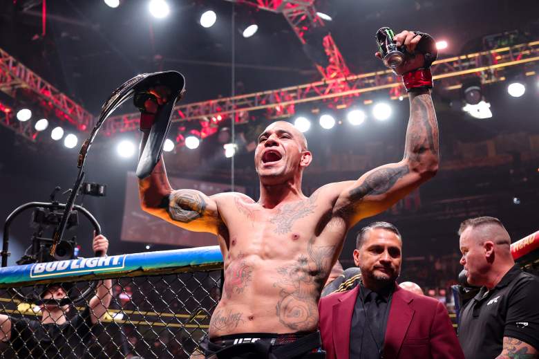Alex Pereira holding up a UFC championship belt