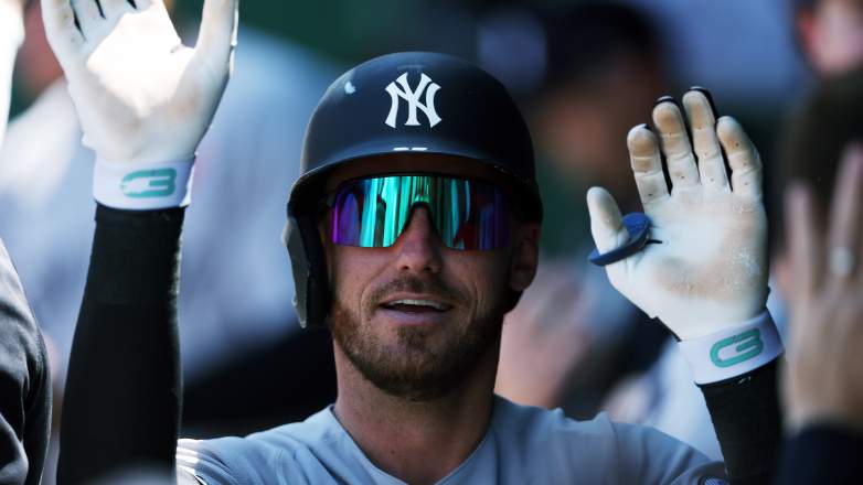 New York Yankees left fielder Cody Bellinger celebrates in the Yankees dugout at Kauffman Stadium.