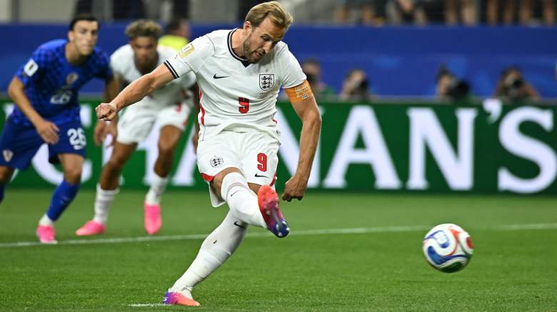 England's forward #09 Harry Kane shoots and scores a retaken penalty.