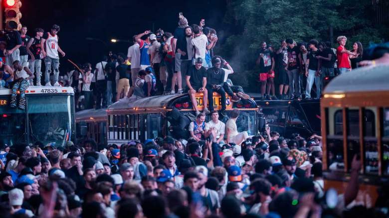 New York Knicks fans climb on buses.