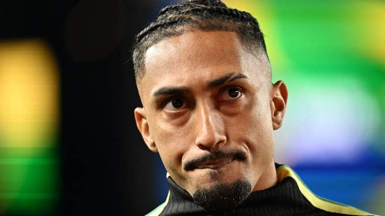 Brazil's forward #11 Raphinha looks on.