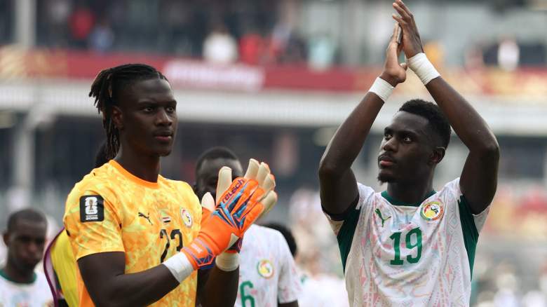 Senegal's goalkeeper #23 Mory Diaw and defender #19 Moussa Niakhate greet fans.
