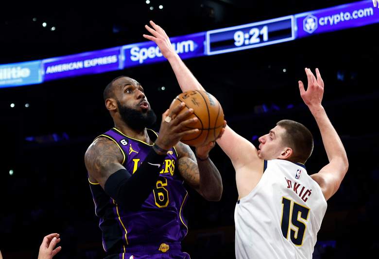 LeBron James attacks the basket as Denver Nuggets center Nikola Jokic defends during a game against the Lakers.