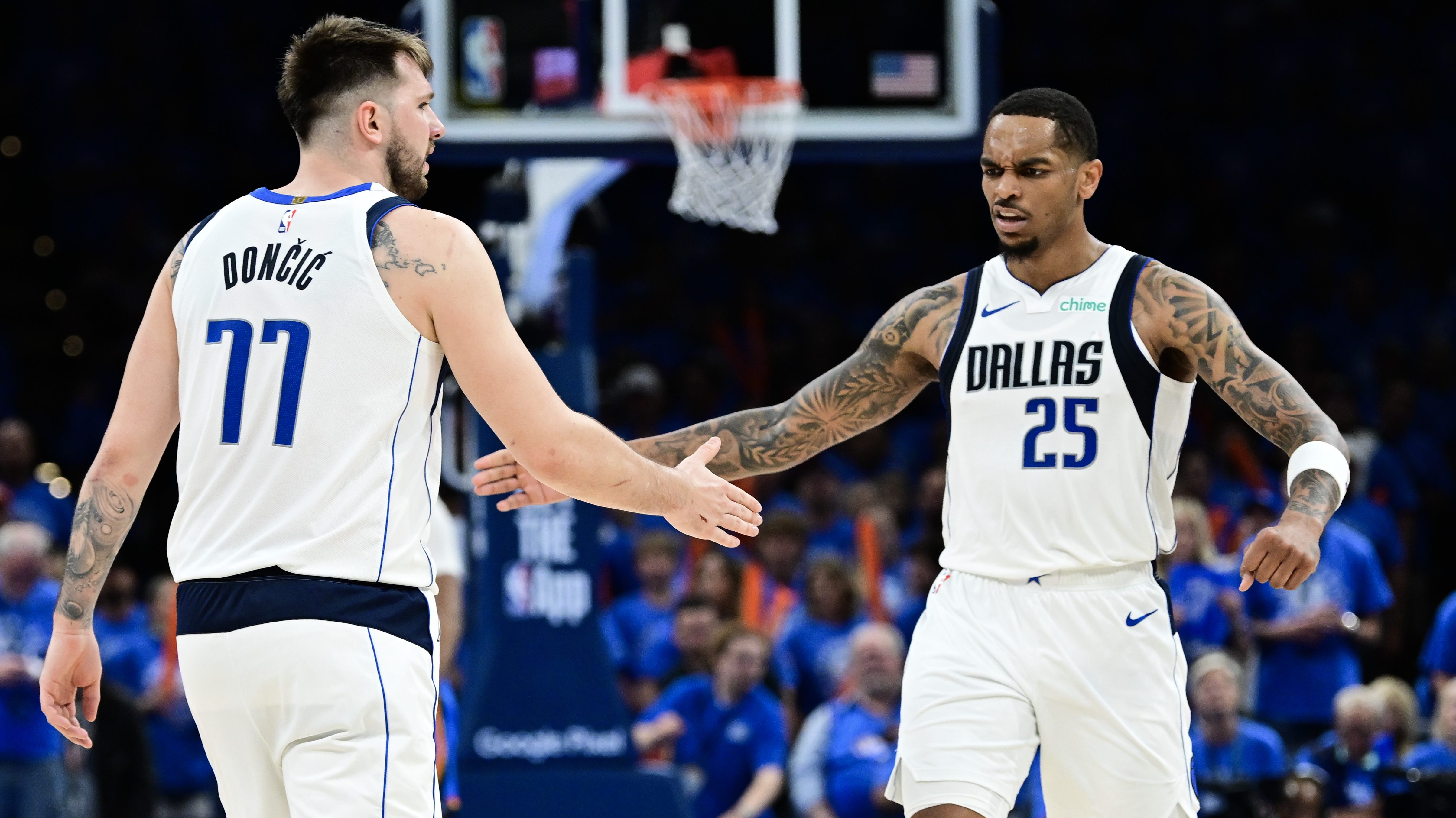 Dallas Mavericks forward PJ Washington celebrates with Luka Dončić during an NBA game.