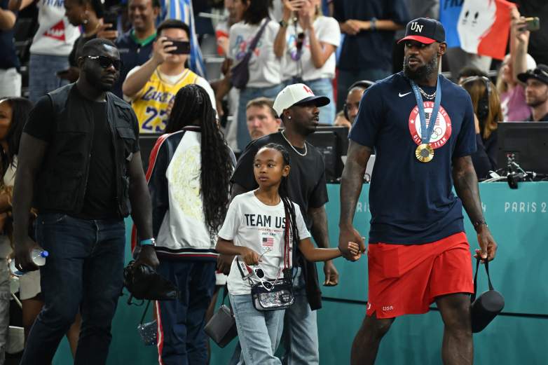 LeBron James walks hand in hand with his daughter, Zhuri, during the 2024 Paris Olympics.