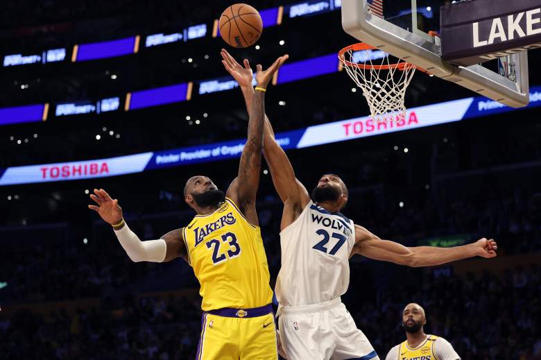 LeBron James attempts a shot while Minnesota Timberwolves center Rudy Gobert contests at the basket during a game against the Los Angeles Lakers.