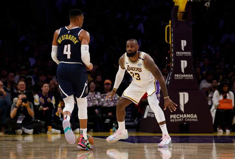 Russell Westbrook brings the ball up the court against LeBron James during an NBA game with the Los Angeles Lakers.