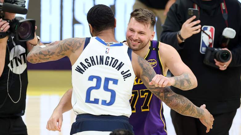 Dallas Mavericks forward P.J. Washington embraces Luka Dončić after an NBA game.