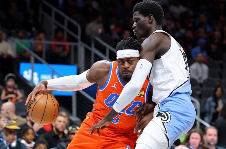 Former Oklahoma City Thunder guard Luguentz Dort drives to the basket against Atlanta Hawks forward Mouhamed Gueye during an NBA game before being traded to Atlanta.