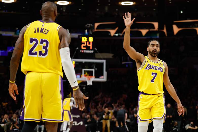 Los Angeles Lakers guard Gabe Vincent high-fives LeBron James during an NBA game as the Miami Heat reportedly explore a reunion.