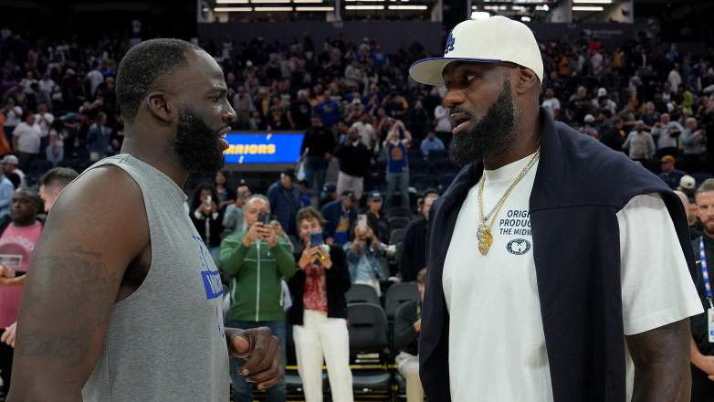 LeBron James talks with Draymond Green before an NBA game as offseason speculation surrounds both players.