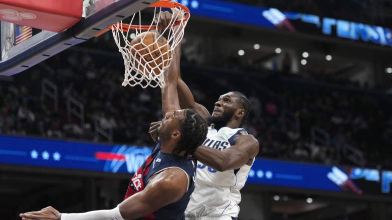 Dallas Mavericks center Moussa Cissé dunks the basketball during an NBA game.