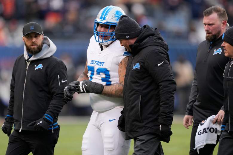 CHICAGO, ILLINOIS - JANUARY 04: Christian Mahogany #73 of the Detroit Lions walks off the field with trainers in the first half against the chiat Soldier Field on January 04, 2026 in Chicago, Illinois. (Photo by Patrick McDermott/Getty Images)