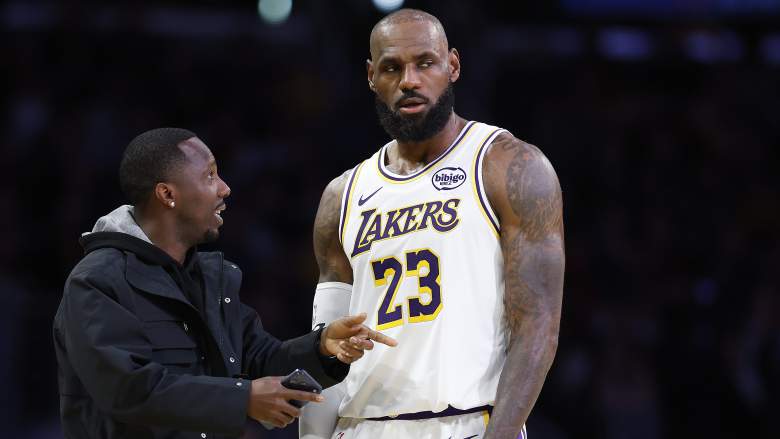 Rich Paul speaks with LeBron James on the court before a Los Angeles Lakers game.