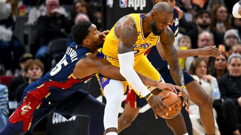 LeBron James protects the basketball from Cleveland Cavaliers guard Donovan Mitchell during a game in Cleveland.