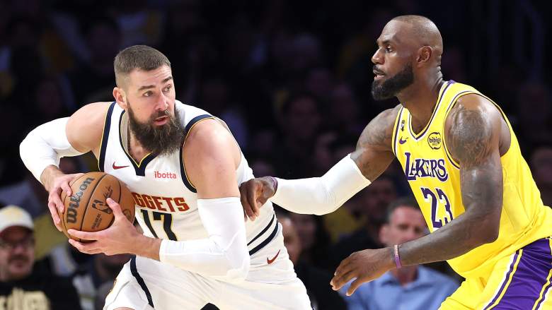 Jonas Valančiūnas posts up LeBron James during an NBA game between the Denver Nuggets and Los Angeles Lakers.