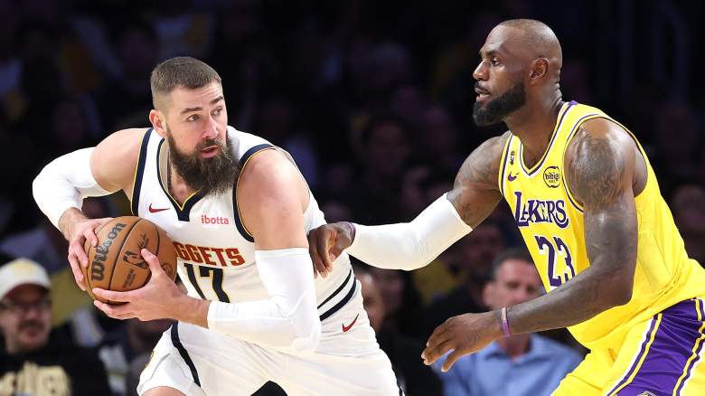 Los Angeles Lakers forward LeBron James defends Denver Nuggets center Jonas Valančiūnas during an NBA game.