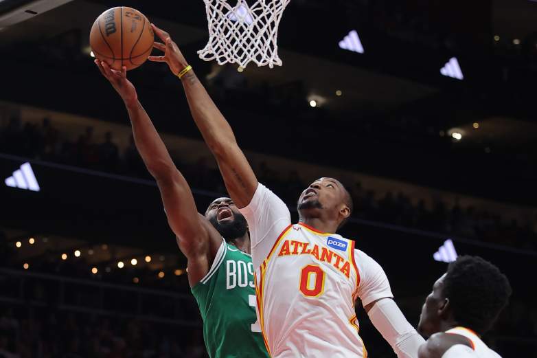 Jonathan Kuminga contests a shot at the rim during a Hawks game as the Lakers pursue a sign-and-trade.