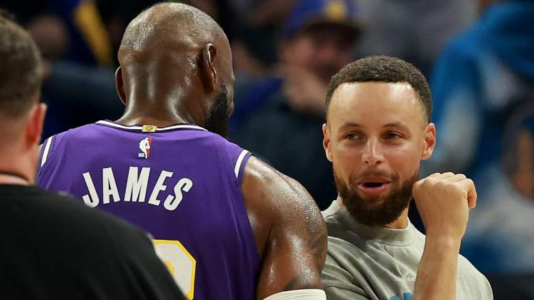 Stephen Curry #30 of the Golden State Warriors speaks to LeBron James #23 of the Los Angeles Lakers. NBA trade rumors have flared for the Warriors.