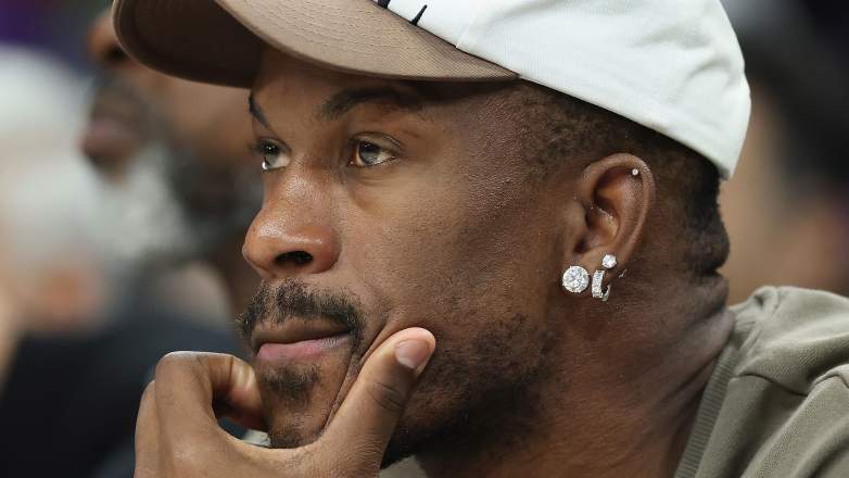 Warriors star Jimmy Butler watches a game from courtside while recovering from ACL surgery