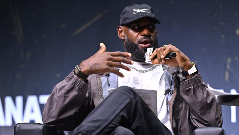 LeBron James gestures while holding a microphone during an appearance at Fanatics Fest in New York.