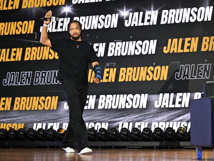 Jalen Brunson waves to fans during his appearance at Fanatics Fest NYC after leading the New York Knicks to the NBA championship.