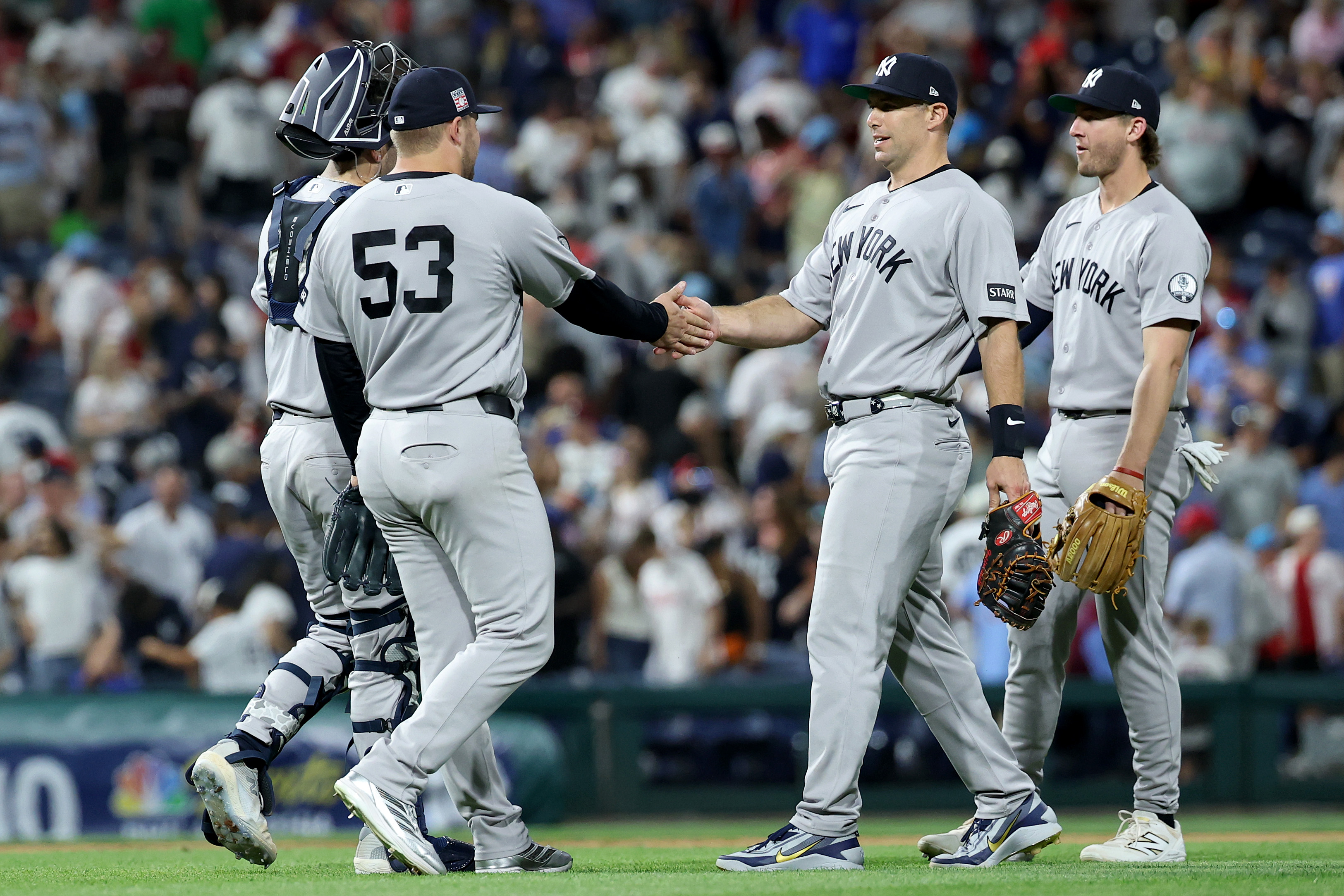 PHILADELPHIA, PENNSYLVANIA - JULY 25: Austin Wells #28, David Bednar #53, Paul Goldschmidt #48 and Ryan McMahon #19 of the New York Yankees celebrate a 3-1 win over the Philadelphia Phillies at Citizens Bank Park on July 25, 2026 in Philadelphia, Pennsylvania. (Photo by Emilee Chinn/Getty Images)