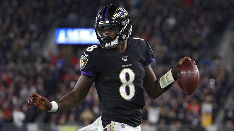 Quarterback Lamar Jackson #8 of the Baltimore Ravens scores a first quarter touchdown against the New England Patriots at M&T Bank Stadium on November 3, 2019 in Baltimore, Maryland