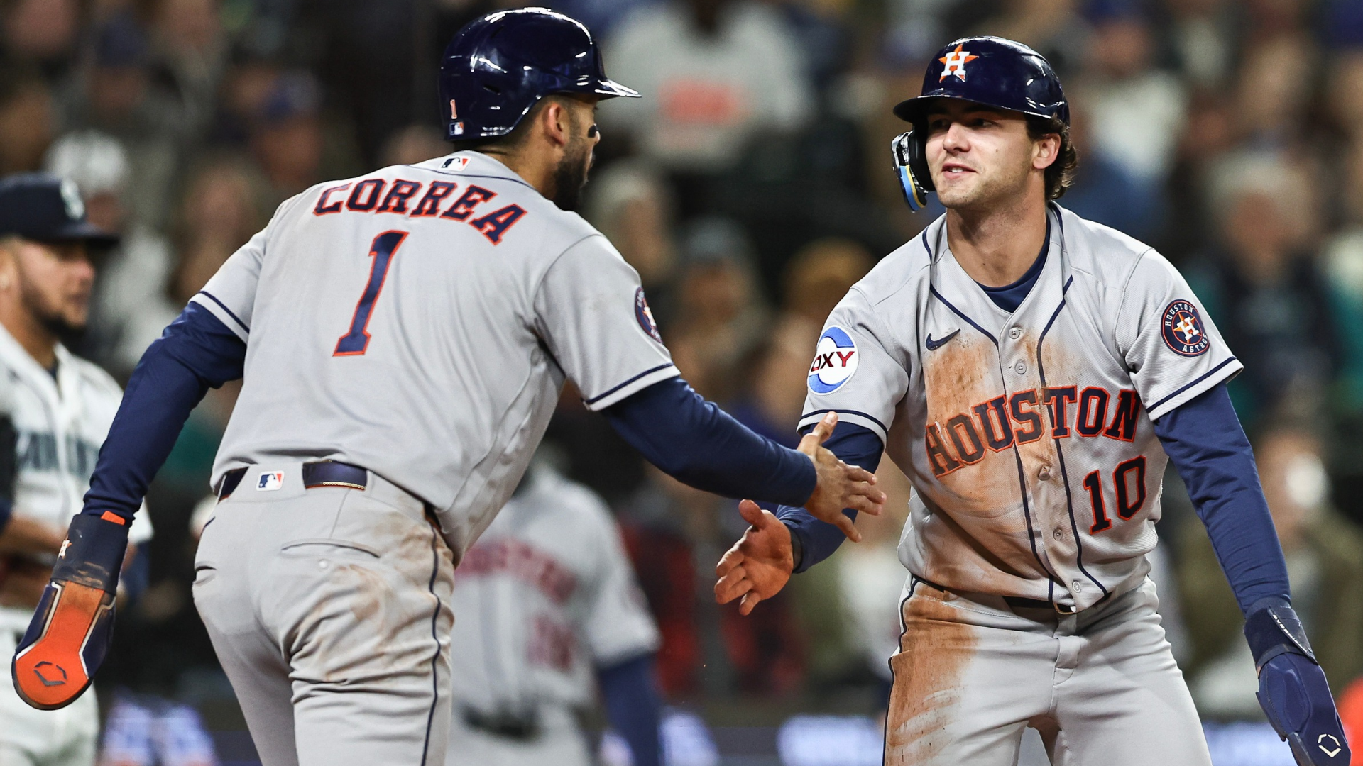 Joey Loperfido #10 of the Houston Astros slaps hands with teammate Carlos Correa #1 after scoring during the third inning against the Seattle Mariners at T-Mobile Park on April 11, 2026 in Seattle, Washington. (Photo by Olivia Vanni/Getty Images)