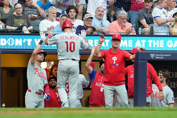 MILWAUKEE, WISCONSIN - JUNE 13: J.T. Realmuto #10 of the Philadelphia Phillies is congratulated by manager Don Mattingly #8 after hitting a three run homer in the sixth inning against the Milwaukee Brewers at American Family Field on June 13, 2026 in Milwaukee, Wisconsin. (Photo by John Fisher/Getty Images)