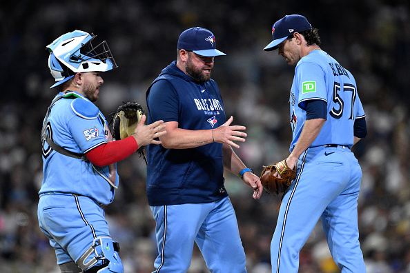 SAN DIEGO, CALIFORNIA - JULY 10: Manager John Schneider #14 of the Toronto Blue Jays takes the ball from Shane Bieber #57 during a pitching change in the fifth inning against the San Diego Padres at Petco Park on July 10, 2026 in San Diego, California. (Photo by Orlando Ramirez/Getty Images)