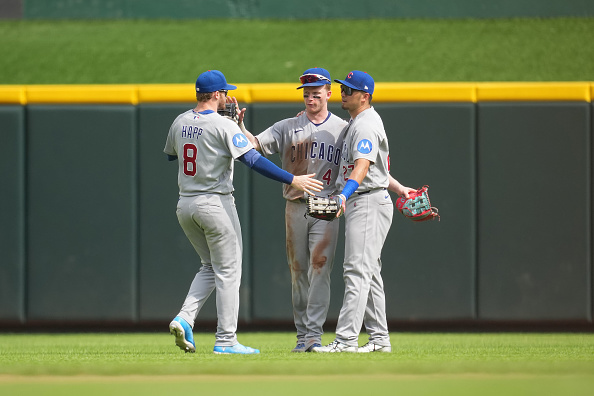 Ian Happ #8 of the Chicago Cubs celebrates with teammates Pete Crow-Armstrong #4 and Seiya Suzuki #27 following a baseball game against the Cincinnati Reds at Great American Ball Park on July 12, 2026 in Cincinnati, Ohio.