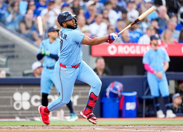 TORONTO, CANADA - JULY 22: Vladimir Guerrero Jr. #27 of the Toronto Blue Jays hits a double against the Tampa Bay Rays during the first inning in their MLB game at the Rogers Centre on July 22, 2026 in Toronto, Ontario, Canada. (Photo by Mark Blinch/Getty Images)