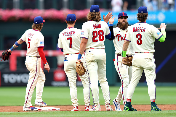 PHILADELPHIA, PENNSYLVANIA - JULY 18: Brandon Marsh #16 celebrates a 6-1 win over the New York Mets with Bryson Stott #5, Trea Turner #7, Alec Bohm #28, and Bryce Harper #3 of the Philadelphia Phillies during a game at Citizens Bank Park on July 18, 2026 in Philadelphia, Pennsylvania. (Photo by Emilee Chinn/Getty Images)
