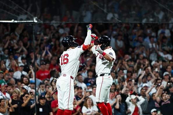 BOSTON, MASSACHUSETTS - JULY 20: Jarren Duran #16 of the Boston Red Sox greets Caleb Durbin #5 at home plate after hitting a solo home run to take the lead in the eighth inning against the Baltimore Orioles at Fenway Park on July 20, 2026 in Boston, Massachusetts. (Photo by Jaiden Tripi/Getty Images)