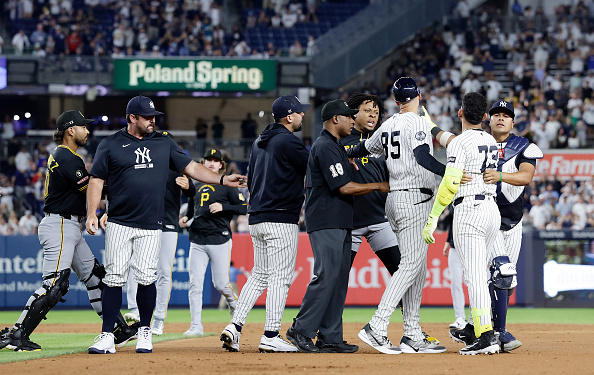 NEW YORK, NEW YORK - JULY 20: Jose Caballero #72 of the New York Yankees is restrained after an altercation against the Pittsburgh Pirates after the eighth inning at Yankee Stadium on July 20, 2026 in New York City. (Photo by Jim McIsaac/Getty Images)