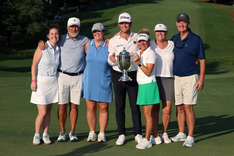 Michael Brennan of the United States poses family after winning the Wyndham Championship