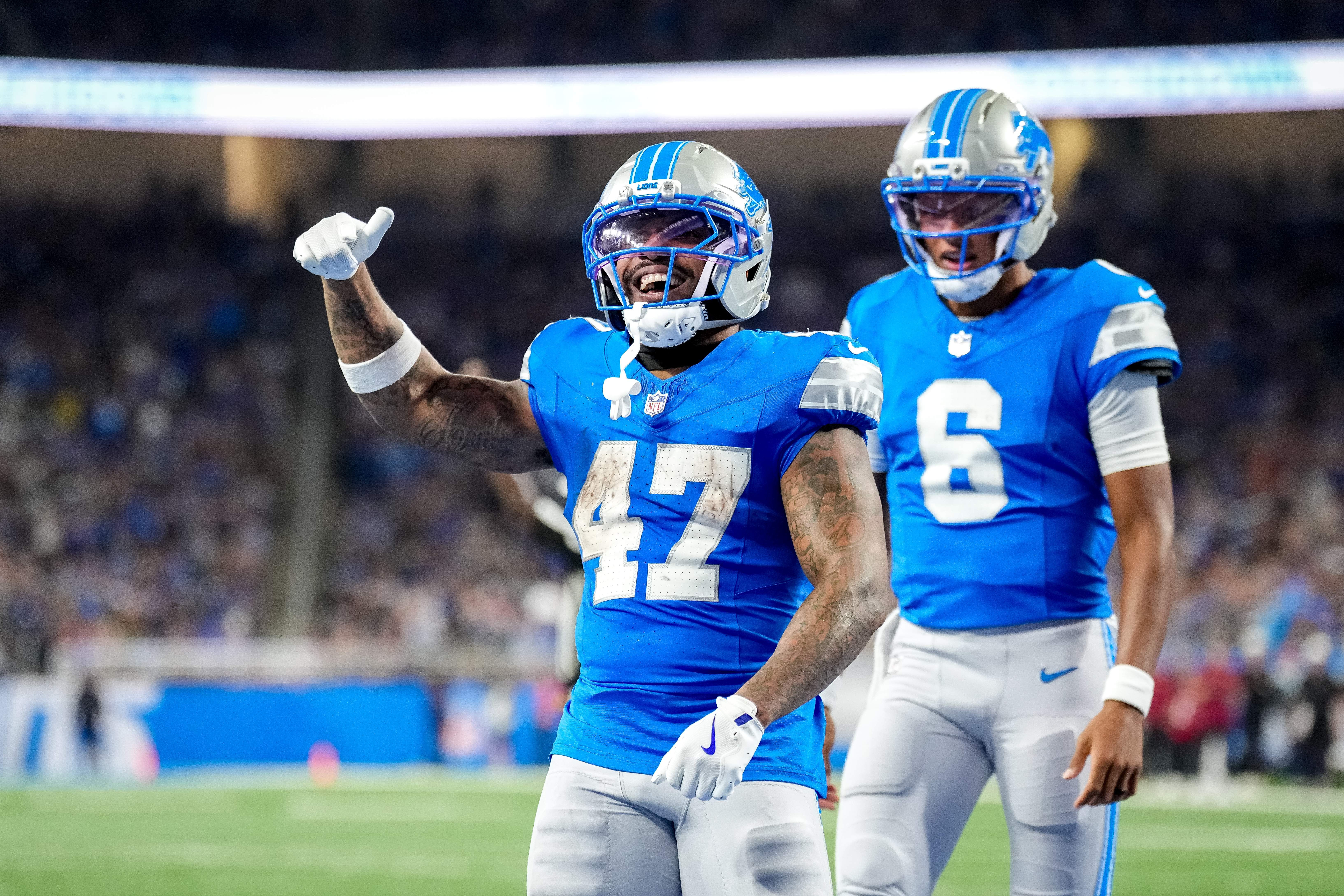 Trayveon Williams #47 and Joshua Dobbs #6 of the Detroit Lions celebrate after Williams scored a touchdown during the third quarter of a preseason game against the Washington Commanders at Ford Field on August 22, 2026 in Detroit, Michigan.